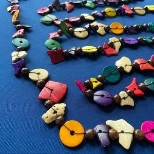 Necklace of 92 inches of bright colored shapes on a black thread